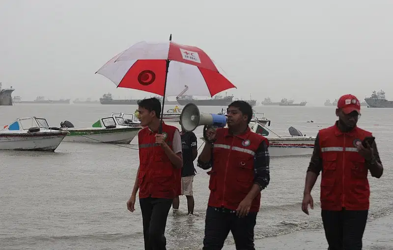 Red Crescent members are asking people to move to a safer place as cyclone Hamoon is approaching towards Bangladesh fast. The photo is taken at Patenga sea port at around 3:00 pm on 24 October, 2023