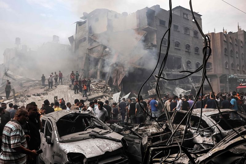 Palestinian search for survivors after an Israeli airstrike on buildings in the refugee camp of Jabalia in the Gaza Strip on October 9, 2023. Israel relentlessly pounded the Gaza Strip early Monday as fighting raged with Hamas around the Gaza Strip and the death toll from the war against the Palestinian militants surged above 1,100