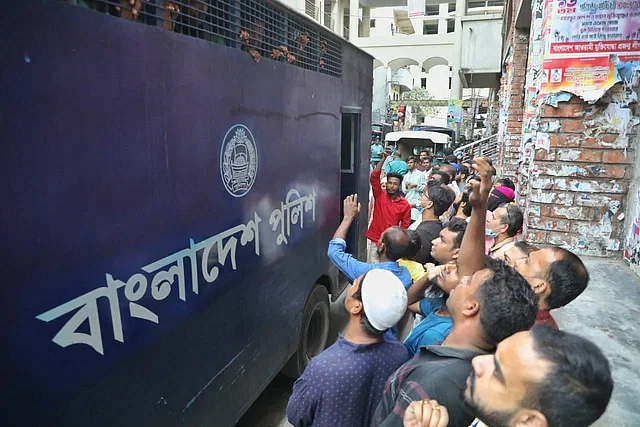 A police vehicle carries prisoners to the court in Dhaka