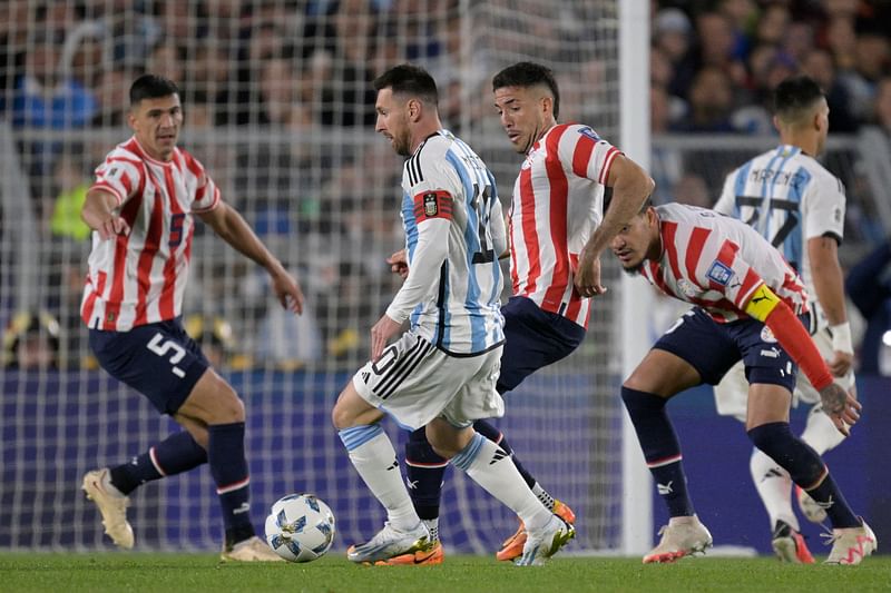 Argentina's forward Lionel Messi and Paraguay's midfielder Alvaro Campuzano fight for the ball during the 2026 FIFA World Cup South American qualification football match between Argentina and Paraguay at the Mas Monumental stadium in Buenos Aires, on 12 October, 2023