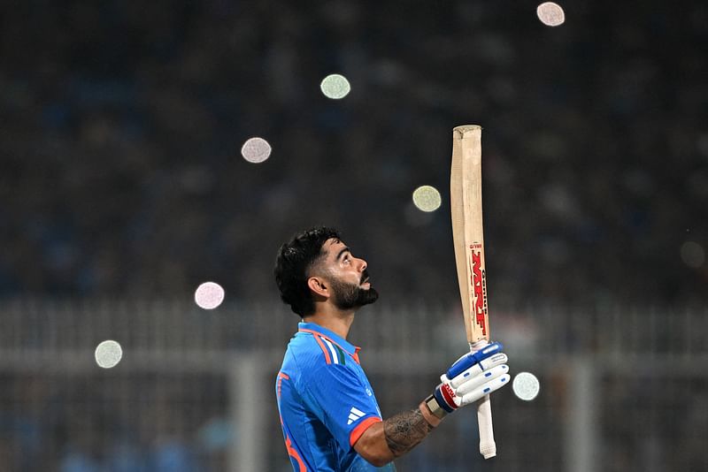 India's Virat Kohli celebrates after scoring a century (100 runs) during the 2023 ICC Men's Cricket World Cup one-day international (ODI) match between India and South Africa at the Eden Gardens in Kolkata on 5 November, 2023.