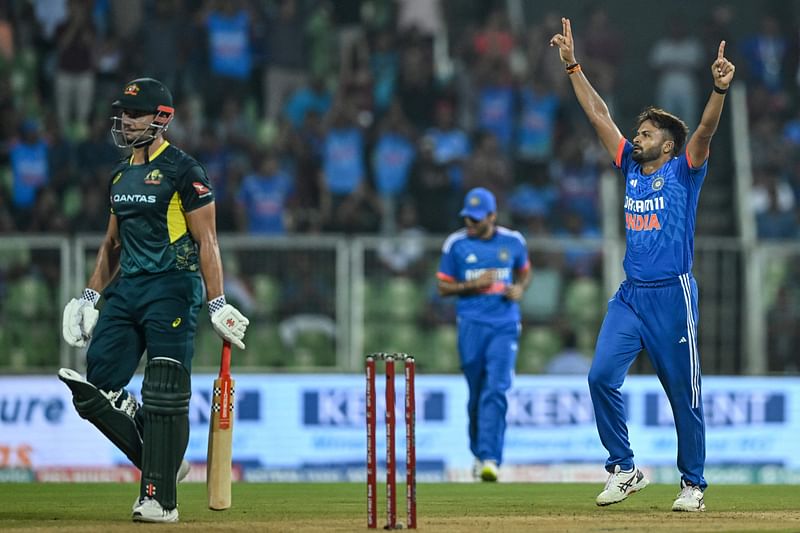 India's Mukesh Kumar celebrates after taking the wicket of Australia's Marcus Stoinis (L) during the second Twenty20 international cricket match between India and Australia at the Greenfield International Stadium in Thiruvananthapuram on 26 November 2023.