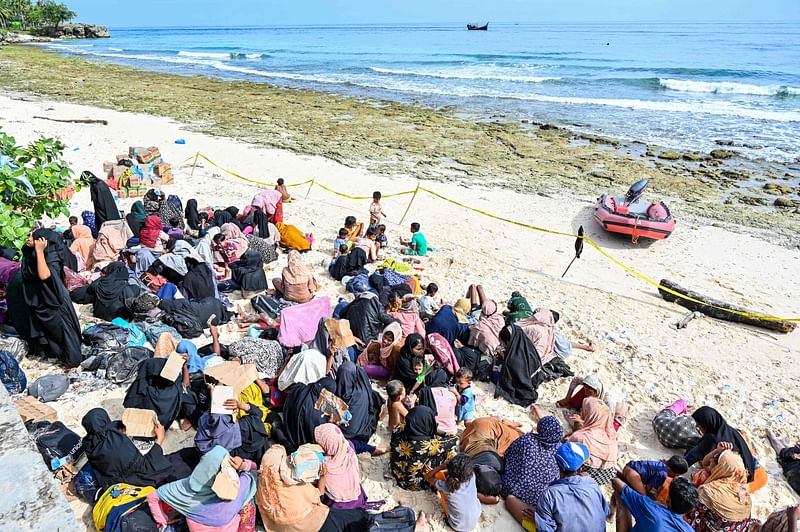 A newly-arrived Rohingya refugee rest on a beach in Sabang island, Aceh province on 22 November, 2023