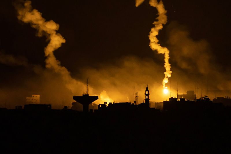 his picture taken from a position near Sderot along the Israeli border with the Gaza Strip early on November 13, 2023, shows flares dropped by Israeli forces above the Palestinian enclave