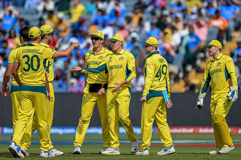 Australia's players celebrate after the dismissal of Bangladesh's Towhid Hridoy during the 2023 ICC Men's Cricket World Cup ODI match against Bangladesh at the Maharashtra Cricket Association Stadium in Pune on 11 November, 2023