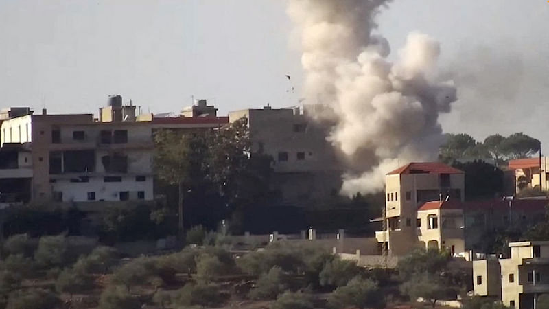 Smoke rises from a building following an Israeli strike on what the Israeli military says are Hezbollah targets in a location given as Lebanon, amid the ongoing cross-border hostilities between Hezbollah and Israeli forces, in this screengrab taken from an undated handout video released on 24 November 2023.