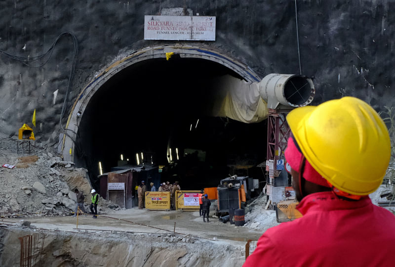 A worker overlooks the entrance of a tunnel where workers have been trapped for ten days after the tunnel collapsed in Uttarkashi, in the northern state of Uttarakhand, India, 22 November, 2023.