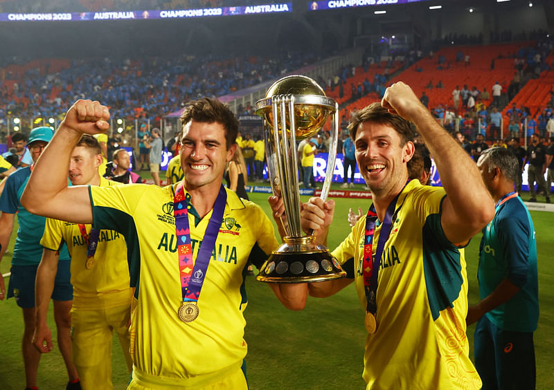 Australia's Pat Cummins and Mitchell Marsh celebrate with the trophy after winning the ICC Cricket World Cup