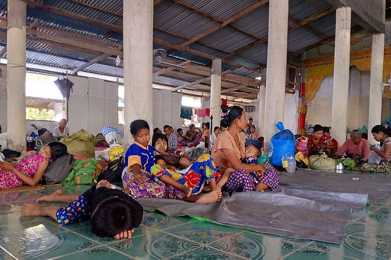 In this photo taken on 23 November, 2023 people rest in a monastery that has turn into a temporary shelter for internally displaced people (IDPs) at a village in Pauktaw township in Myanmar's western Rakhine State