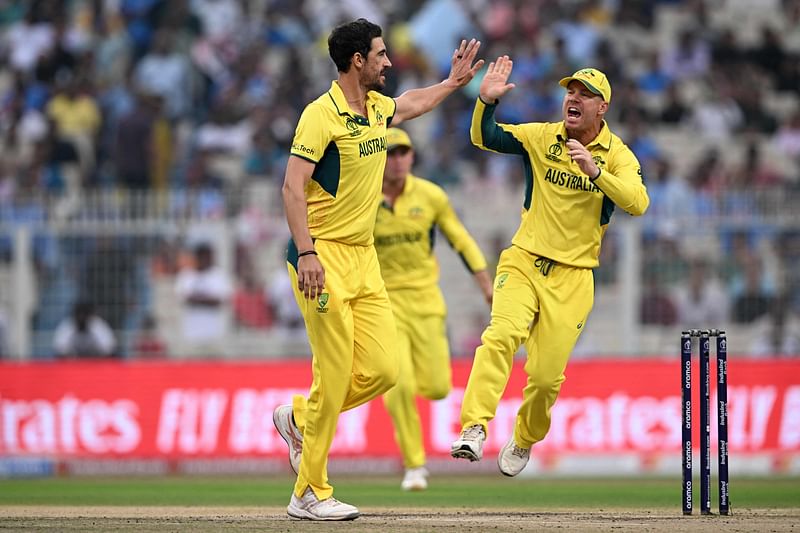 ustralia's Mitchell Starc (L) celebrates with teammate after taking the wicket of South Africa's captain Temba Bavuma during the 2023 ICC Men's Cricket World Cup one-day international (ODI) second semi-final match between Australia and South Africa at the Eden Gardens in Kolkata on November 16, 2023