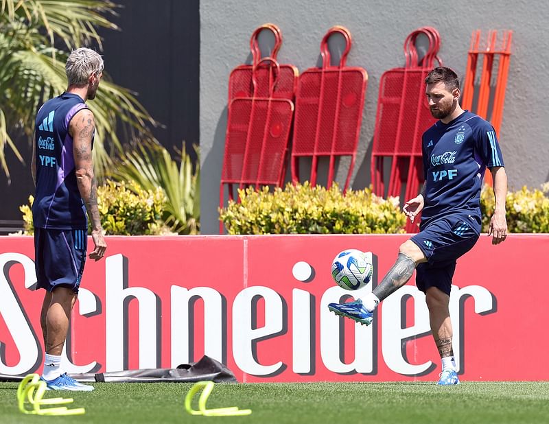 Argentina's forward Lionel Messi (R) controls the ball next to Argentina's midfielder Rodrigo De Paul during a training session in Ezeiza, Buenos Aires Province, on 20 November, 2023