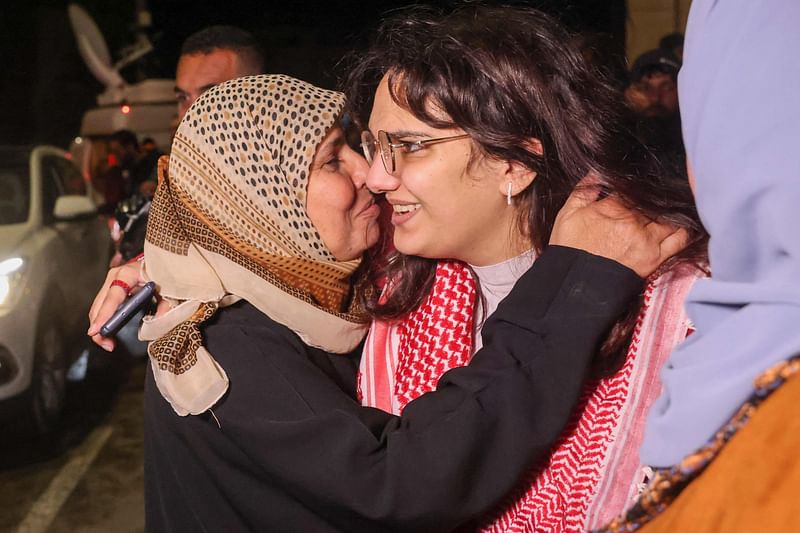 Hanin Barghouti (C) a Palestinian prisoner held in an Israeli prison is greeted by her family on her release under a truce deal between Israel and Hamas in exchange for hostages held in Gaza, in Baytunia in the occupied West Bank on 
24 November, 2023