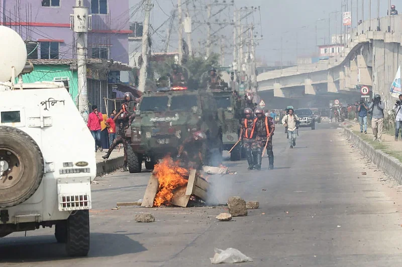 RAB and BGB members disperse the demonstrating readymade garments workers from Dhaka-Tangail highway in Gazipur on 9 November, 2023