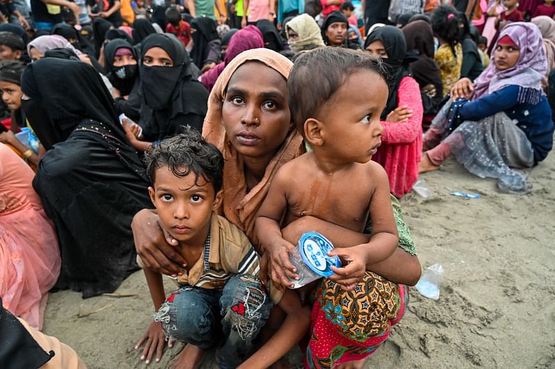 Newly-arrived Rohingya refugees wait to be transferred to a shelter in Batee beach, Aceh province, Indonesia, on 15 November, 2023.