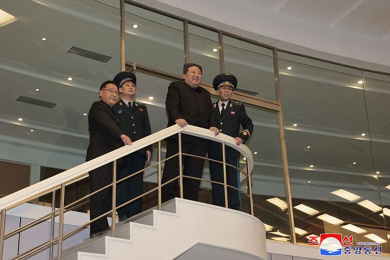 This picture taken and released on 22 November, 2023 from North Korea's official Korean Central News Agency (KCNA) shows North Korea's leader Kim Jong Un (2nd R) visiting the Pyongyang General Control Centre of the Korean National Aerospace Technology Directorate, a day after the launch of a rocket carrying the reconnaissance satellite 'Malligyong-1', in Pyongyang