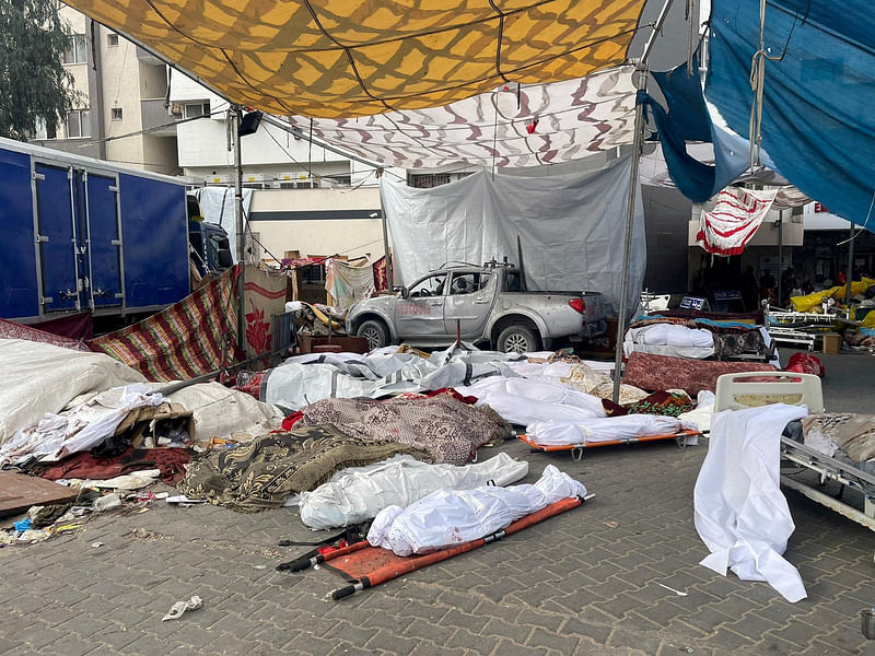 Bodies of Palestinians killed in Israeli strikes lie on the ground at the yard of Al Shifa hospital as health officials say they are unable to bury them due to the Israeli ground operation around the hospital, in Gaza City November 12, 2023