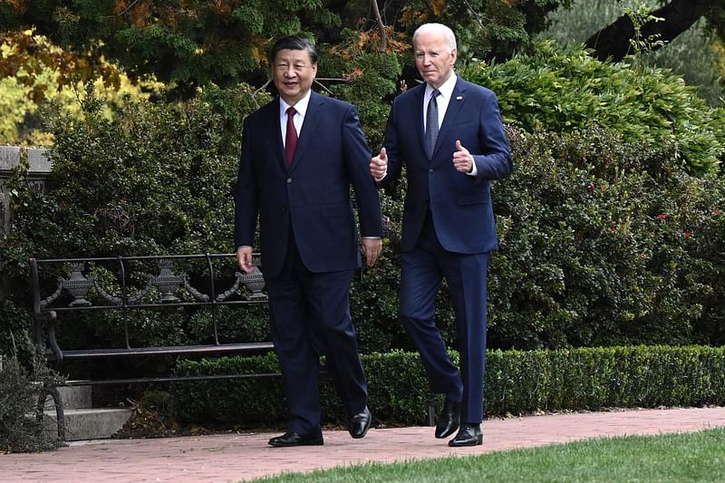 US President Joe Biden (R) and Chinese President Xi Jinping walk together after a meeting during the Asia-Pacific Economic Cooperation (APEC) Leaders’ week in Woodside, California on 15 November, 2023