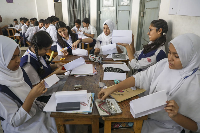 Students of class VII are busy in practical work on mathematics as part of the new annual evaluation method.