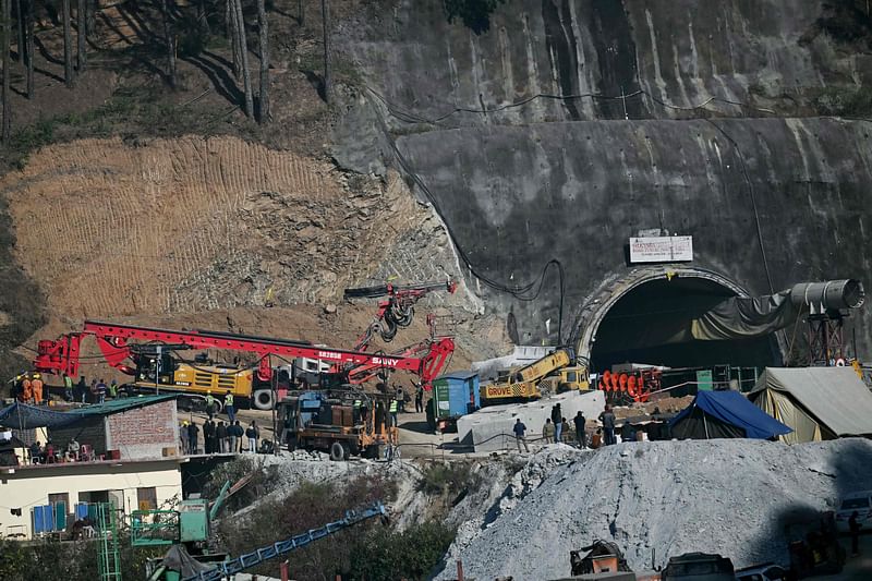 Rescue personnel move a digging machine during rescue operation for workers trapped in the Silkyara under construction road tunnel, days after it collapsed in the Uttarkashi district of India's Uttarakhand state on 25 November, 2023