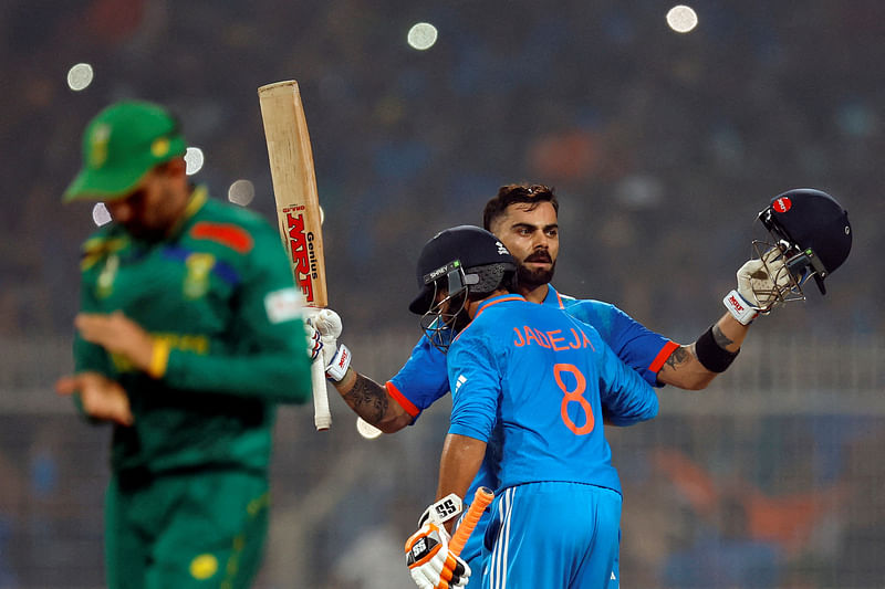 Virat Kohli celebrates with Ravindra Jadeja after reaching his 49th century, equalizing with Sachin Tendulkar's record of most number of ODI centuries