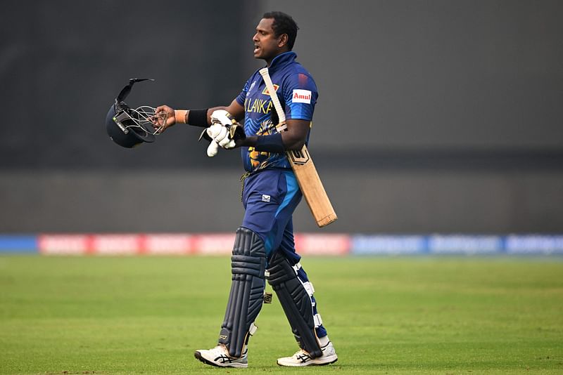 Sri Lanka's Angelo Mathews walks back to the pavilion after he was timed out during the 2023 ICC Men's Cricket World Cup one-day international (ODI) match between Bangladesh and Sri Lanka at the Arun Jaitley Stadium in New Delhi on 6 November, 2023