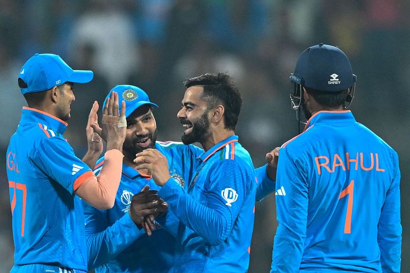 India's Virat Kohli (2R) celebrates with Shubman Gill (L), captain Rohit Sharma (2L) and KL Rahul after taking the wicket of Netherlands' captain Scott Edwards