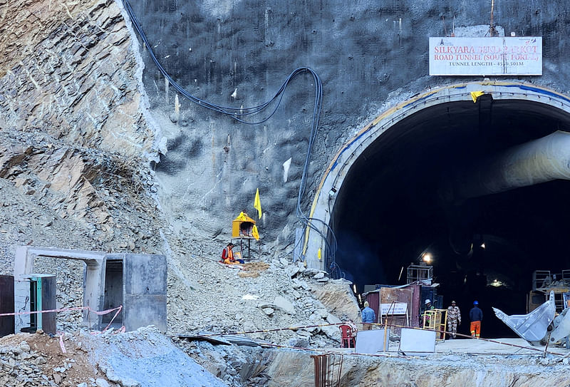 A Hindu priest prays at a makeshift shrine outside the entrance of a tunnel where workers are trapped after a portion of the tunnel collapsed in Uttarkashi in the northern state of Uttarakhand, India, November 21, 2023