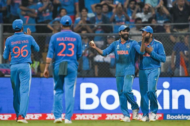 India's Ravindra Jadeja (2R) celebrates with teammates after taking a catch to dismiss New Zealand's Glenn Phillips during the 2023 ICC Men's Cricket World Cup one-day international (ODI) first semi-final match between India and New Zealand at the Wankhede Stadium in Mumbai on 15 November 2023.