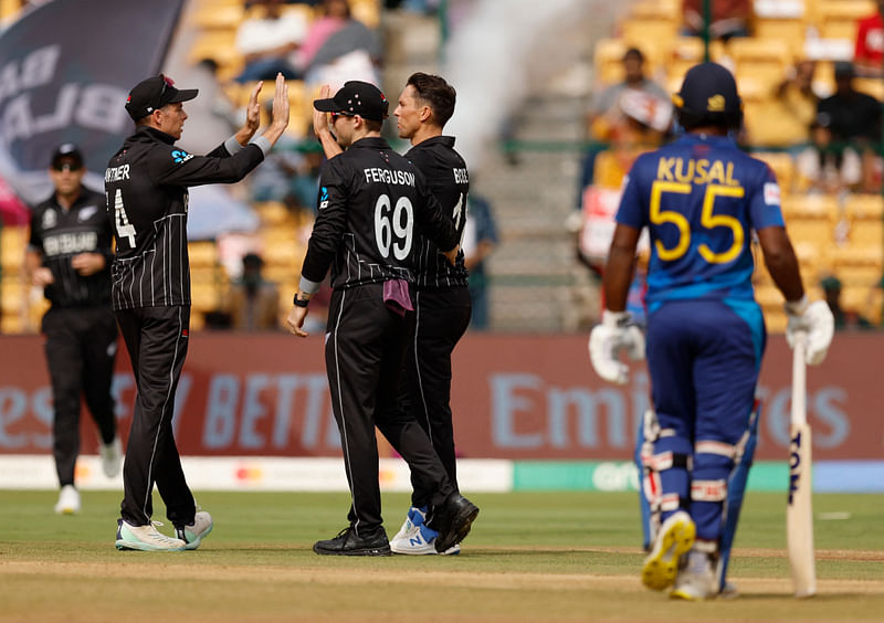 New Zealand's Trent Boult celebrates with Mitch Santner and Lockie Ferguson after taking a catch to dismiss Sri Lanka's Sadeera Samarawickrama