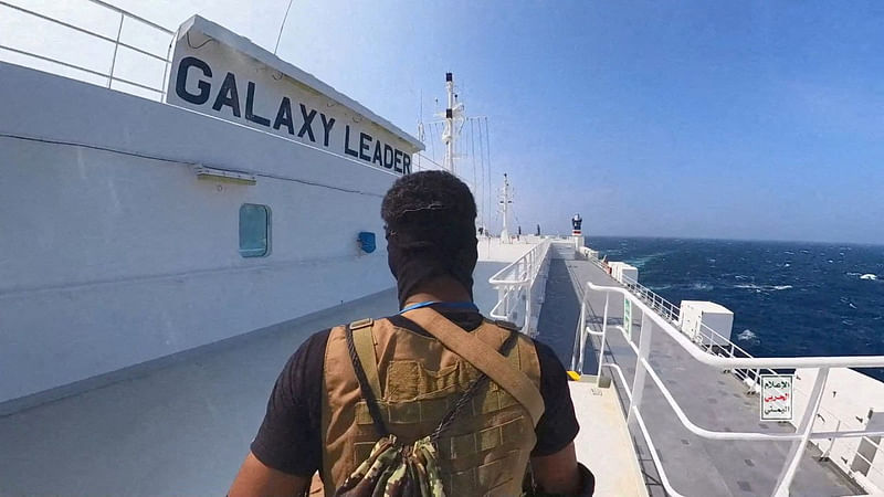 A Houthi fighter stands on the Galaxy Leader cargo ship in the Red Sea in this photo released November 20, 2023