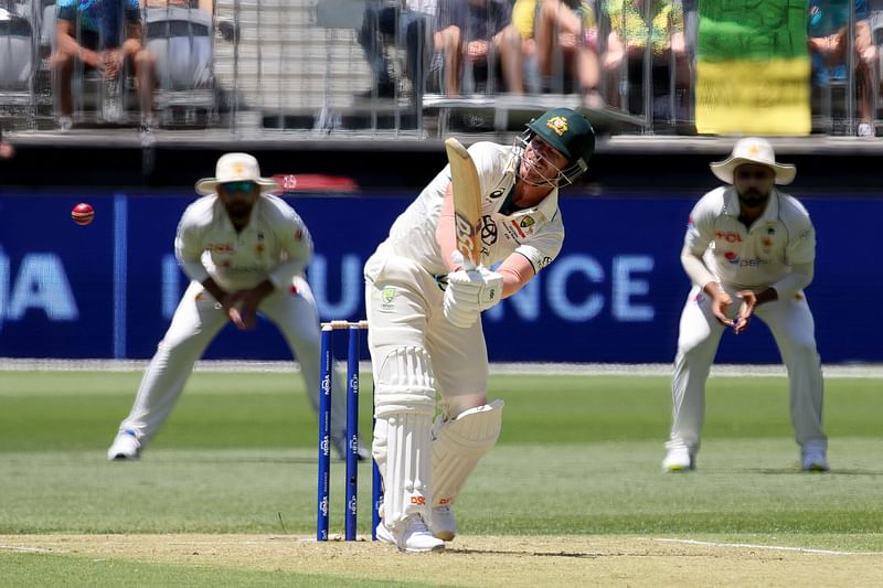 Australia’s David Warner (C) plays a shot during the first day of the first Test cricket match between Australia and Pakistan at Optus Stadium in Perth on December 14, 2023