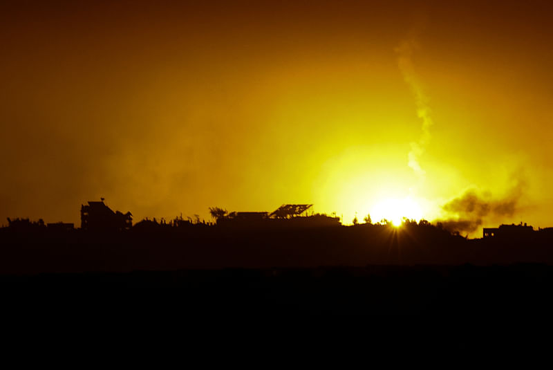 A flare falls over Gaza, amid the ongoing conflict between Israel and the Palestinian Islamist group Hamas, as seen from southern Israel, December 7, 2023