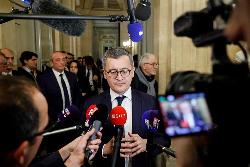 French Interior Minister Gerald Darmanin speaks to the press following the vote and the approval of the draft law to control immigration, at the French National Assembly in Paris on 19 December, 2023