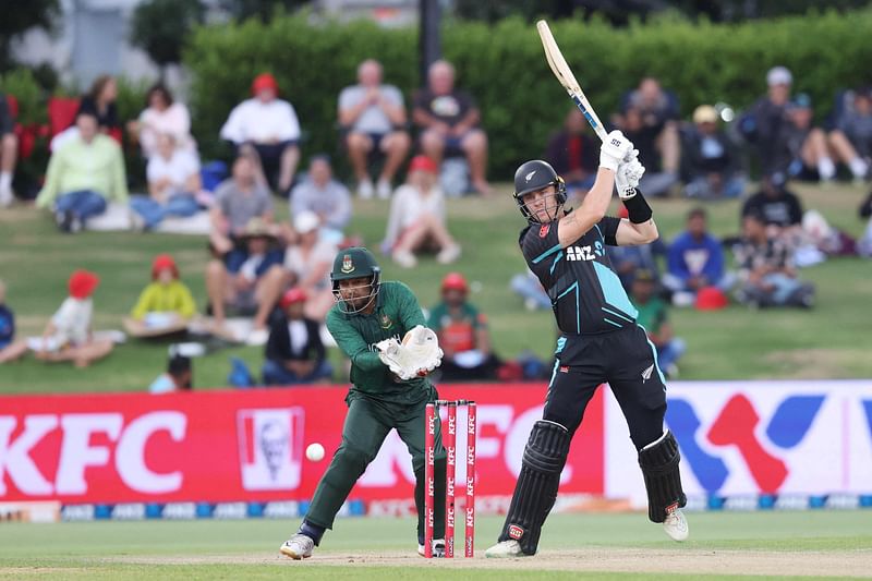 New Zealand's Finn Allen (R) plays a shot in front of Bangladesh’s wicketkeeper Rony Talukdar during the second Twenty20 cricket match between New Zealand and Bangladesh at Bay Oval in Mount Maunganui on 29 December, 2023