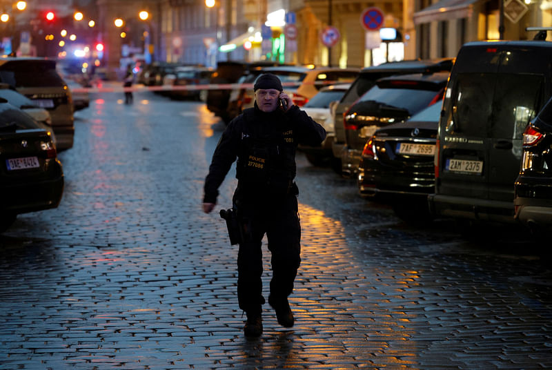 A police officer secures the area following the shooting at one of the buildings of Charles University in Prague, Czech Republic, December 21, 2023