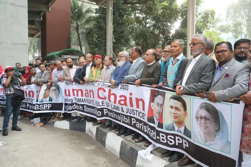 Bangladesh Sommilito Peshajibi Parishad organises a human chain in front of the National Press Club in Dhaka on 10 December 2023.