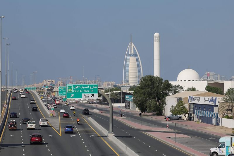 Traffic flows past Dubai's Gargash mosque (R) and its landmark Burj al-Arab (C) luxury hotel on 10 December 2023. The United Arab Emirates suffers from high air pollution levels fed by its fossil fuel industry, Human Rights Watch warned earlier this month, as the oil-rich country hosts the UN's COP28 climate talks in Dubai.