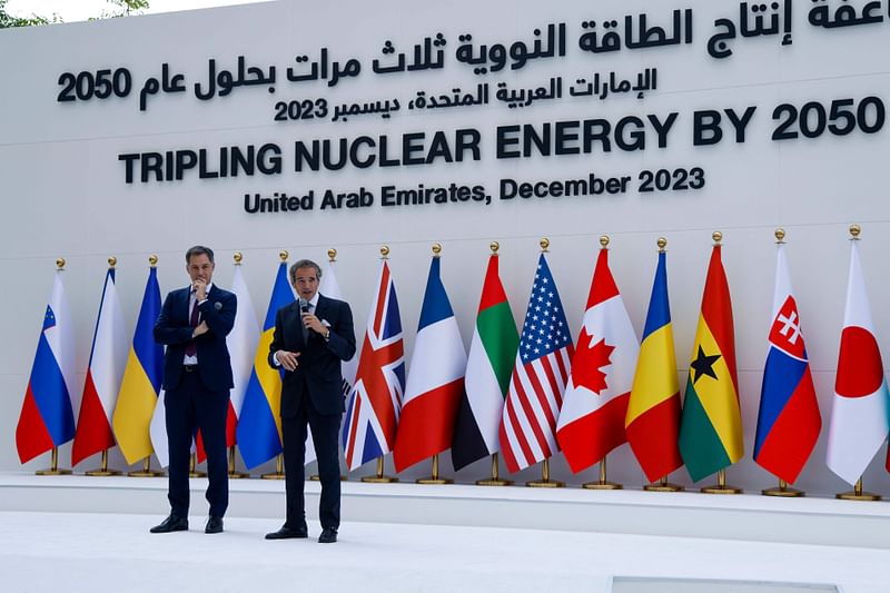 Belgium prime minister Alexander De Croo (L) listens as IAEA director general Rafael Grossi speaks during the Tripling Nuclear Energy by 2050 session at the United Nations climate summit in Dubai on 2 December, 2023