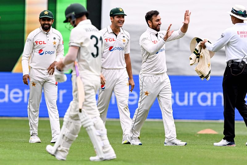 Pakistan's bowler Agha Salman (R) celebrates with teammates after dismissing Australia's batsman David Warner (2nd L) on the first day of the second cricket Test match between Australia and Pakistan at the Melbourne Cricket Ground (MCG) in Melbourne on December 26, 2023