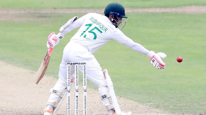 Mushfiqur Rahim pushes the ball back away with his gloves in the second session of day 1 of second Test between Bangladesh and New Zealand at Sher-e-Bangla National Cricket Stadium in Mirpur, Dhaka, on 6 December in 2023