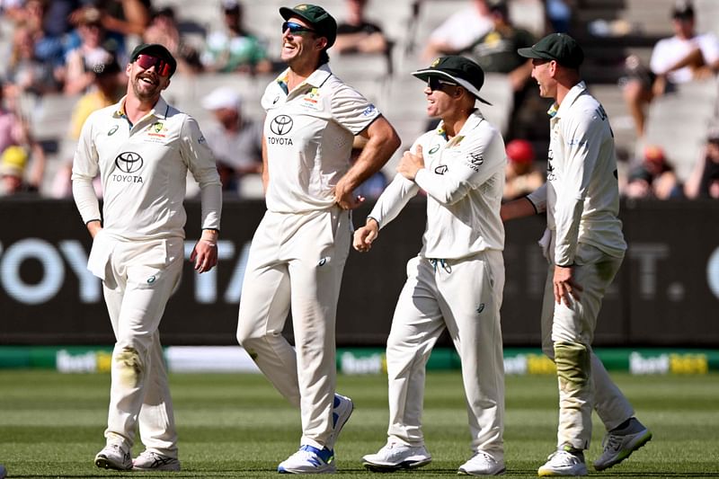 Australia’s Mitch Marsh (2nd L) celebrates with teammates Travis Head (L), David Warner (2nd R) and Marnus Labuschagne (R) after taking a catch to dimiss Pakistan’s batsman Shan Masood on the second day of the second cricket Test match between Australia and Pakistan at the Melbourne Cricket Ground (MCG) in Melbourne on 27 December, 2023