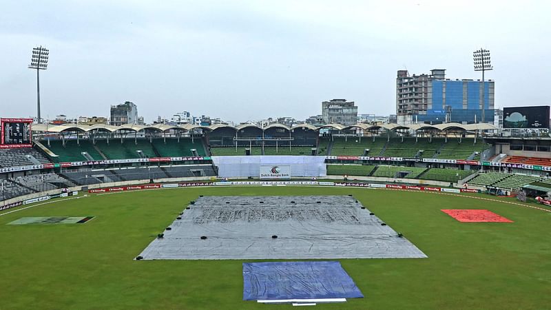 The covered pitch is pictured as rain delays the second day play of the second Test cricket match between Bangladesh and New Zealand at the Sher-E-Bangla National Cricket Stadium in Dhaka on 7 December, 2023