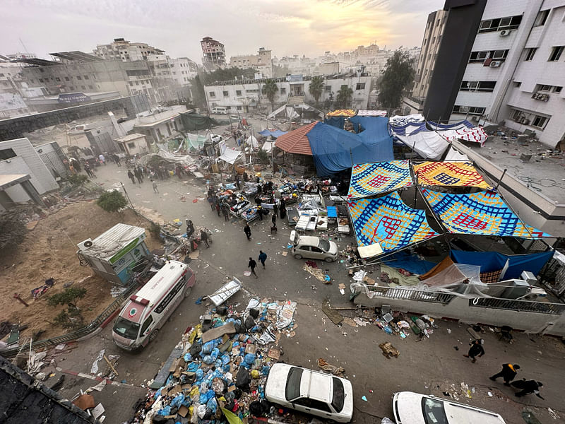 Palestinians inspect Al Shifa Hospital which was raided by Israeli forces during its ground operation, amid a temporary truce between Israel and the Palestinian Islamist group Hamas, in Gaza City, November 25, 2023