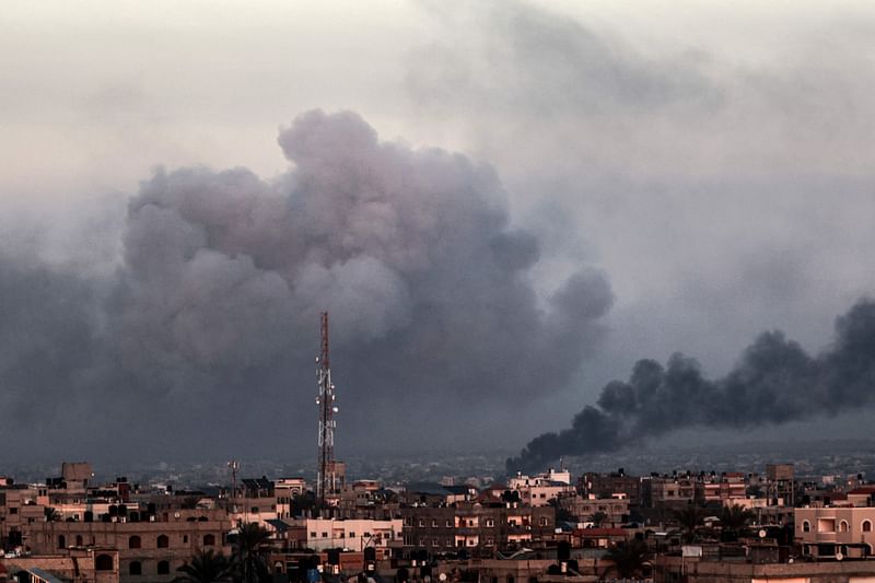 This picture taken from Rafah shows smoke billowing over Khan Yunis in the southern Gaza Strip during Israeli bombardment on 16 January 2024, amid ongoing battles between Israel and the Palestinian militant group Hamas.