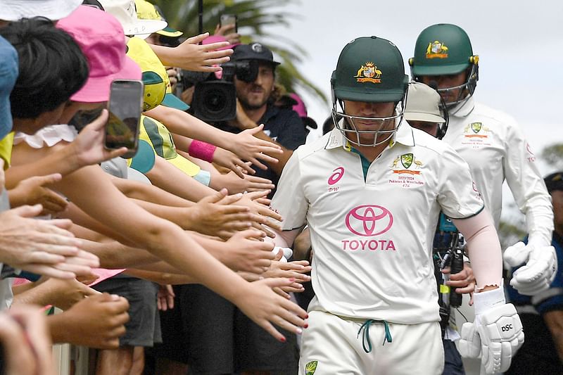 Fans cheer on Australia’s David Warner as he walks out to bat for the last time in his 112th and farewell Test during day four of the third cricket Test match between Australia and Pakistan at the Sydney Cricket Ground in Sydney on 6 January 2024.