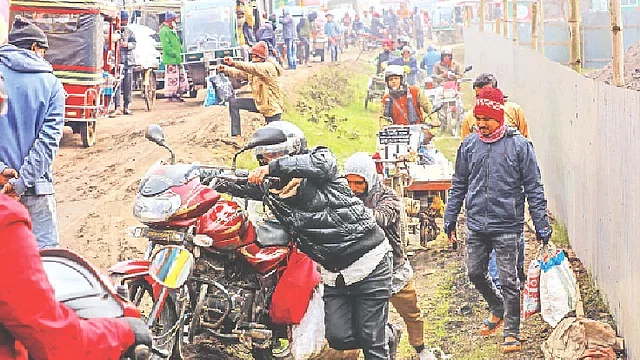 Commuters suffer as a new phase of repair works is underway on the Jashore-Nawapara road, blocking a lane. The photo was taken from Chengutiya of Jashore on 22 January, 2024.