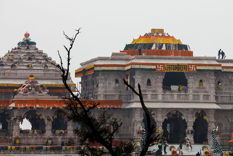 Police officers stand on top of the decorated temple of Hindu Lord Ram on the eve of its opening in Ayodhya, in India, 21 January 2024.