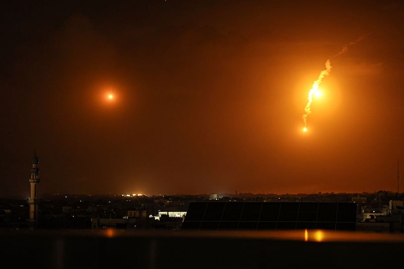 A picture taken from Rafah on January 10, 2024, shows flares fired by Israeli troops over Khan Yunis in the southern Gaza Strip, amid ongoing battles between Israel and the Palestinian militant group Hamas