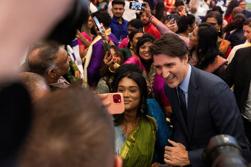 Canada’s Prime Minister Justin Trudeau poses for a selfie with a member of Quebec’s Tamil community during a Tamil Heritage Month event in Laval, Quebec, Canada on 21 January 2024.