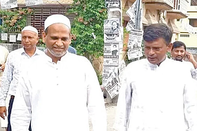 Photo shows Rajshahi-4 lawmaker Enamul Haque and Purba Banglar Communist Party (PBCP-Red Flag) leader Abdur Razzaque aka Art Babu (R) during a poll campaign.